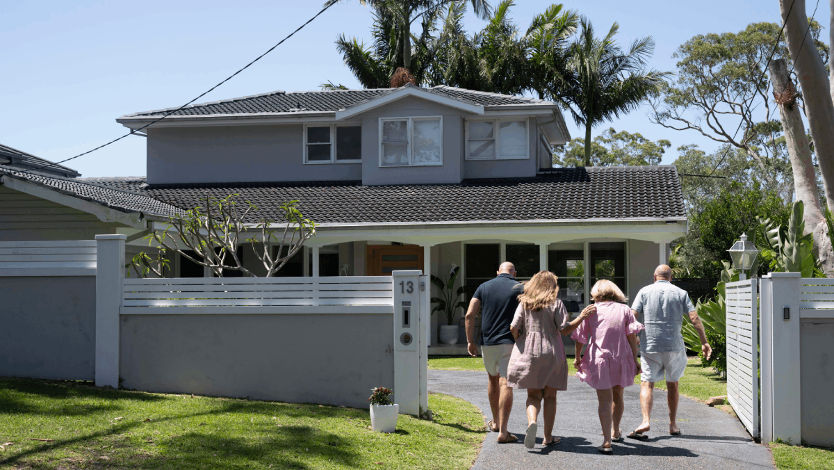 family walking into their new home