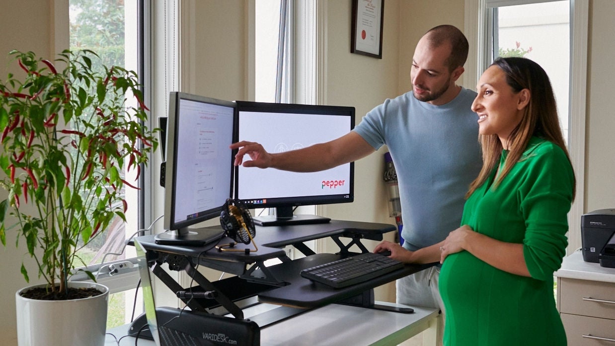 Pregnant couple reviewing their loan rate options at Pepper Money