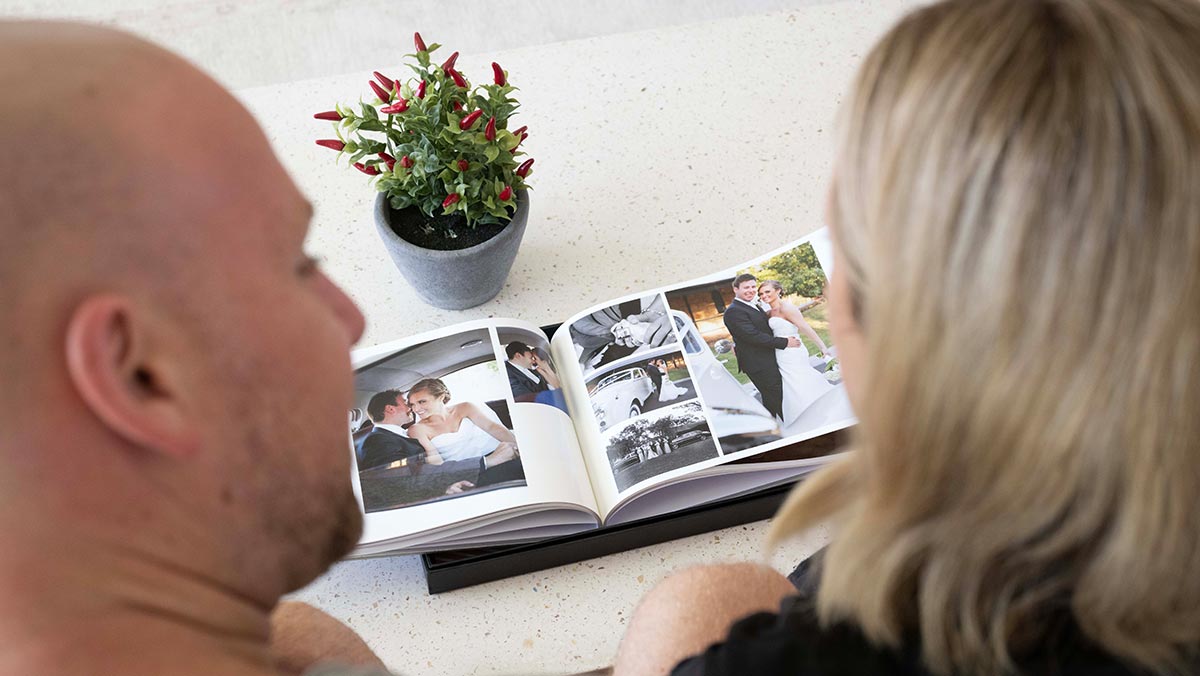 couple looking at their wedding photos