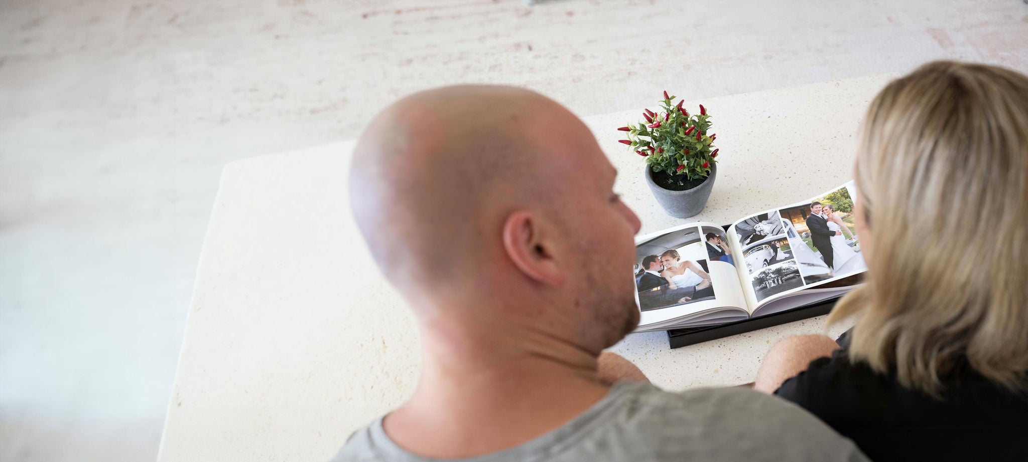 couple looking at their wedding photos