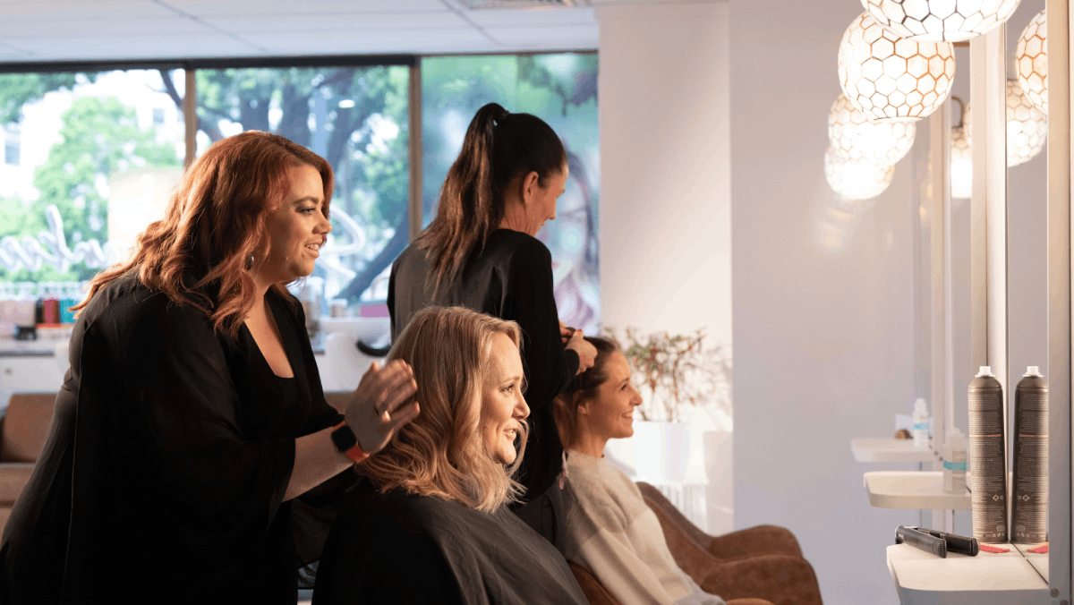 salon owner chatting with her customers