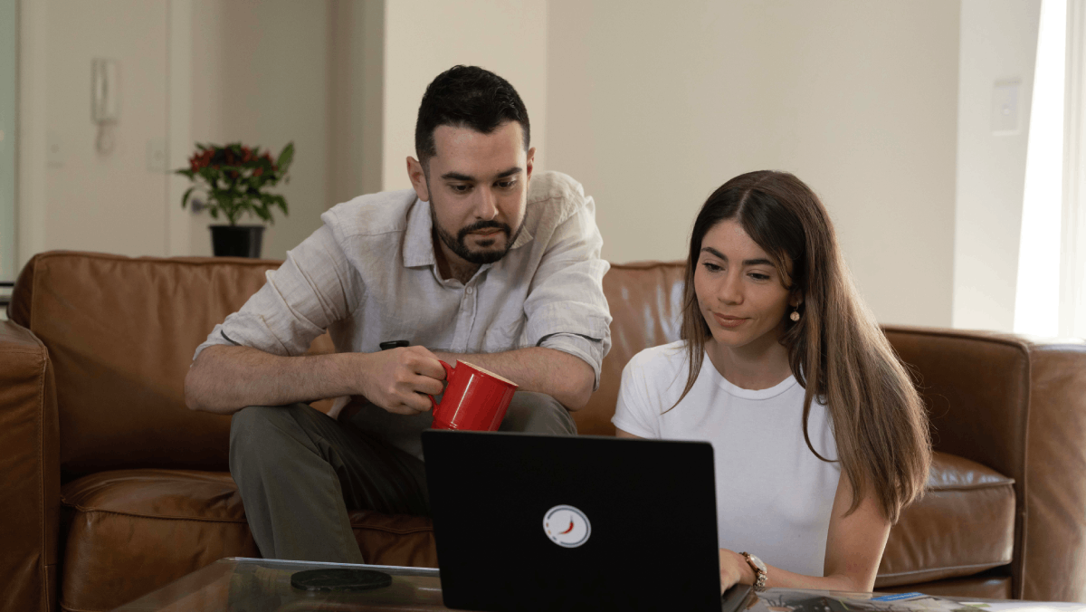 a couple in front of a laptop thinking if it's safe to enter their card details